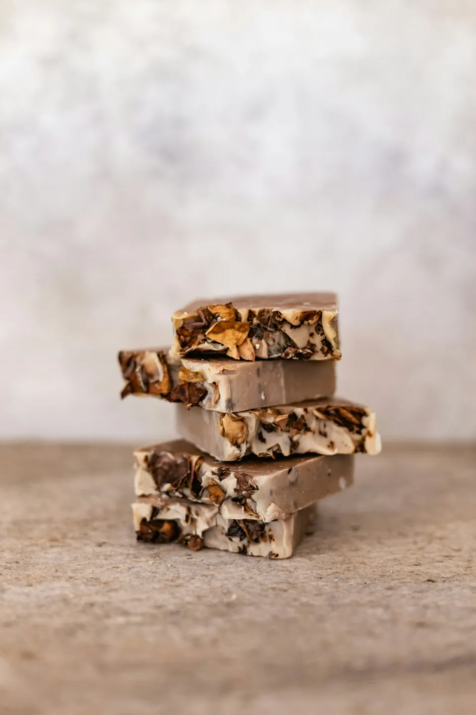 Pieces of rich fudge stacked on a light surface